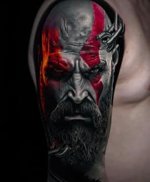 A realistic tattoo of Kratos from God of War, with a red stripe across his face and chains on his shoulder.